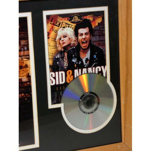 323 - A signed print of Gary Oldman and Chloe Webb from the film Sid and Nancy, signed print mounted along... 