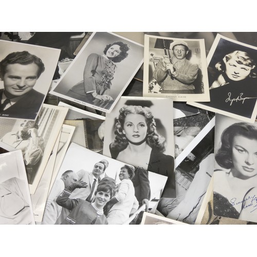 324 - A collection of signed and unsigned celebrity headshots, on set photos and magazine cuttings, mostly... 