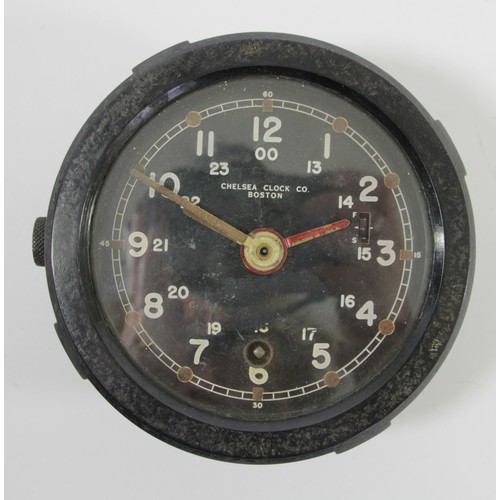 367 - A US Army M1 Message Center bulkhead clock, the 10cm circular black enamel dial with luminous hands,... 