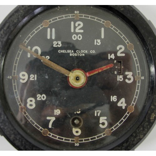 367 - A US Army M1 Message Center bulkhead clock, the 10cm circular black enamel dial with luminous hands,... 