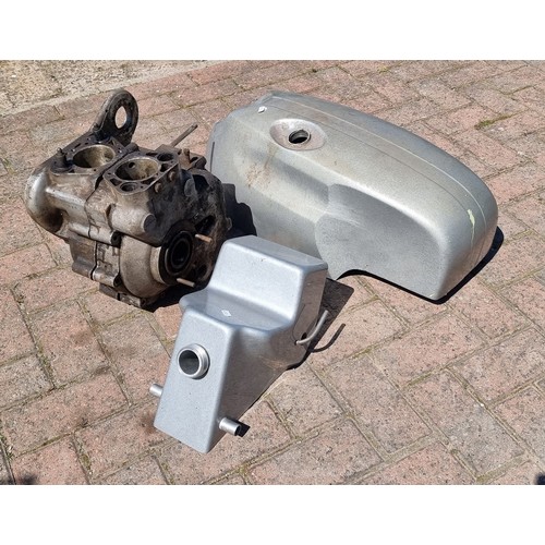 85 - A Norton fibreglass petrol tank and oil tank, together with Royal Enfield crankcase