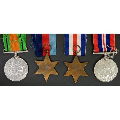 399 - WWII group of four, ribbons, Defense, 1939-1945 Star, France and Germany Star and a War medal, box w... 