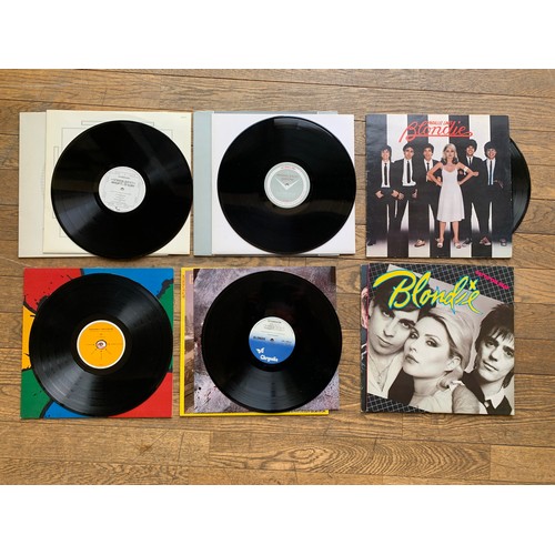 155 - A collection of over one hundred LPs and Singles, including artists such as Queen, David Bowie, Elto... 