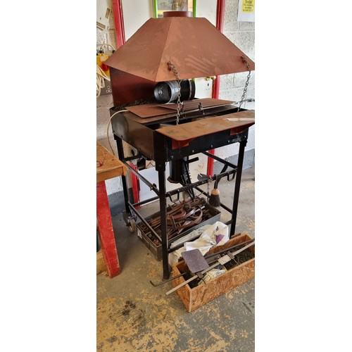 18 - A blacksmith made workshop forge with electric fan, mounted on wheels, various tongs and tools as we... 