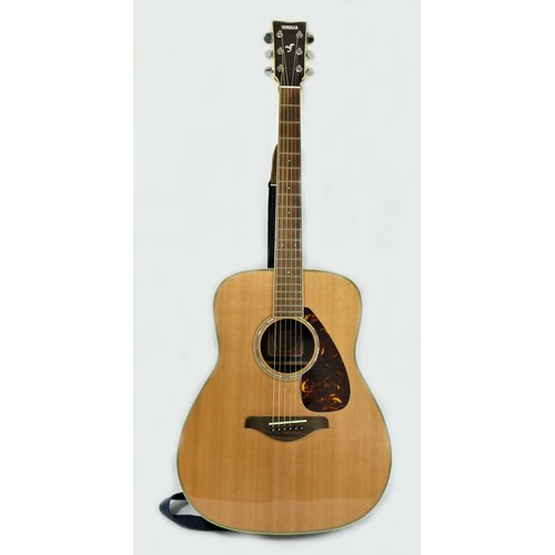 A Yamaha FG730S acoustic guitar, fender strap