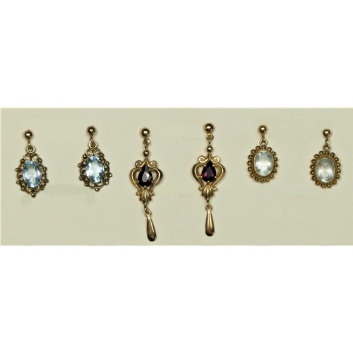 287 - A 9ct gold and aquamarine pair of ear rings, a blue topaz pair and a garnet pair, 4.7gm