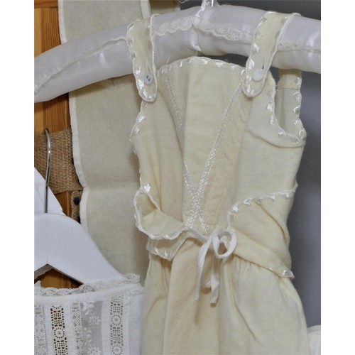 57 - White cotton embroidered christening gowns and cream embroidered layettes. Average 64cm length (9)