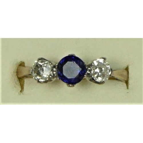 44 - An 18ct gold sapphire and diamond three stone, the mixed cut stone flanked by old diamonds of approx... 