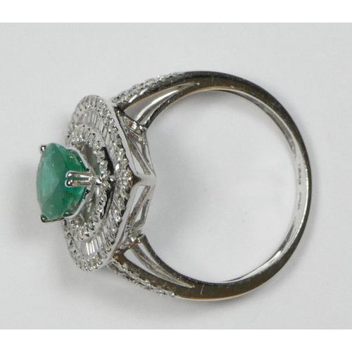 66 - An 18ct white gold emerald and diamond cluster ring, claw set with a pear cut stone, approximately 0... 