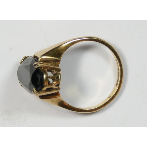 74 - A 9ct gold and smokey quartz dress ring, claw set with an oval mixed cut stone, 19 x 9mm, O, 4.6gm