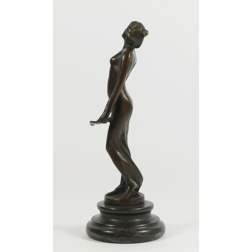 125 - A bronze figurine of a flapper girl holding a tray, on a stepped circular marble base.
19cm tall.