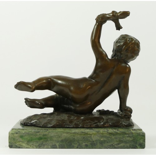 128 - After Faguie, a 20th Century French bronze figurine in the form of a cherub putti, modelled holding ... 