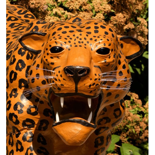 137 - A paper mache sculpture, in the form of a leopard, plastic teeth and whiskers, 100cm x 70cm x 30cm