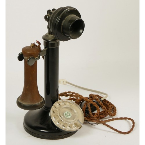 138 - A GEC style black painted candlestick telephone with adjustable speaker, height 30cm.