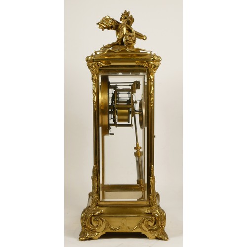 226 - Samuel Marti et Cie, Paris, a late 19th century brass four glass mantel clock, the white enamel two ... 