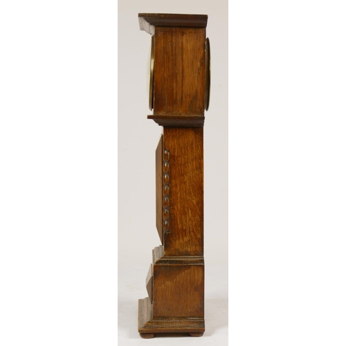 234 - A late 19th Century oak miniature longcase clock, by X.L the movement by Hamburg American Clock Comp... 