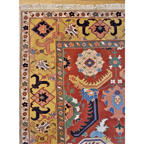 270 - A Turkish Konya rug with multi-coloured guls on a brick red field, palmette and gul border, 290 x 22... 