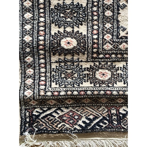 272 - A Pakistani Bokhara runner with two rows of guls on a sandy field, 82 x 370cm and a similar rug, 122... 