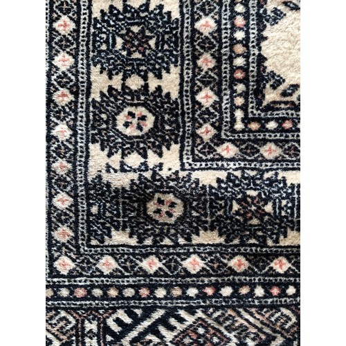 273 - A Pakistani Bokhara runner with a single row of guls on a sandy field, 81 x 294cm and a similar rug,... 