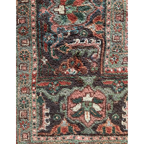 274 - A Persian Hamaden rug, with deep red field, palmette and floral border, 240 x 322cm.