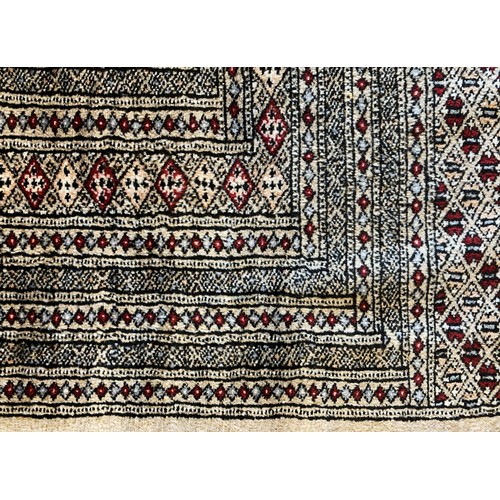 275 - A Pakistani Bokhara rug, with multiple guls on a red field, 238 x 350cm.