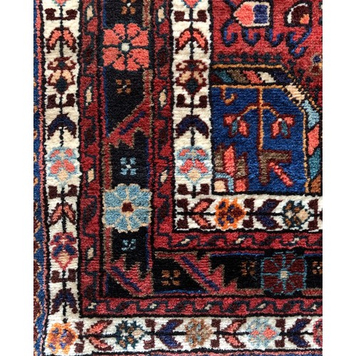 276 - A Persian Tuyserkan Hamaden wool rug, medallion design predominantly in red, blue and cream, 143 x 2... 