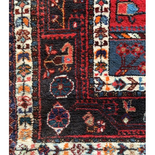 277 - A Persian Tuyserkan Hamaden wool rug, medallion design predominantly in red, blue and cream, 139 x 2... 