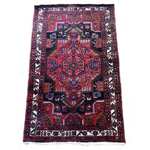 278 - A Persian Tuyserkan Hamaden wool rug, medallion design predominantly in red, blue and cream, 118 x 1... 