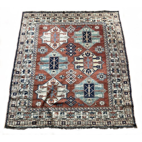 279 - A Caucasian Kazak rug, with brick red field, 180 x 195cm