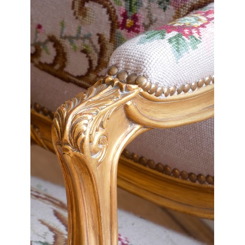 291 - A Louis XV style giltwood and petite point embroidered salon suite, comprising three seat sofa with ... 