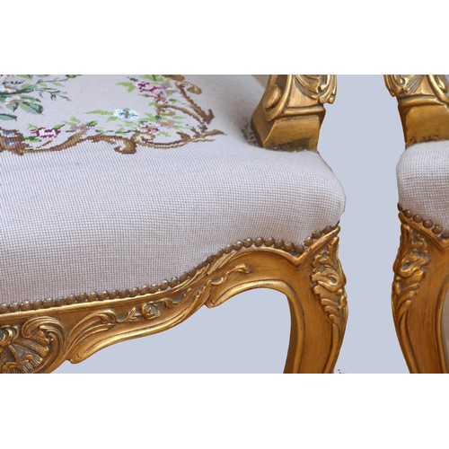 292 - A Louis XV style giltwood and petite point embroidered pair of armchairs, to match the previous lot,... 