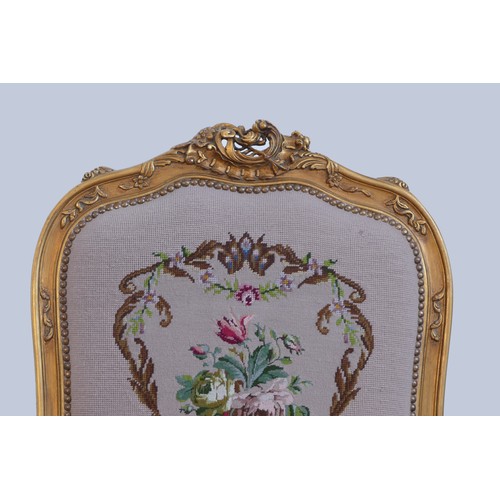 292 - A Louis XV style giltwood and petite point embroidered pair of armchairs, to match the previous lot,... 