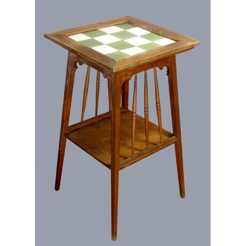 297 - An Arts and Crafts oak tapering occasional table, with chequerboard tile insert, 40 x 70cm.