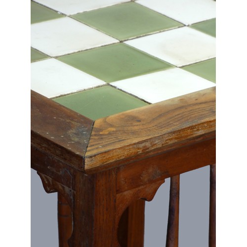 297 - An Arts and Crafts oak tapering occasional table, with chequerboard tile insert, 40 x 70cm.