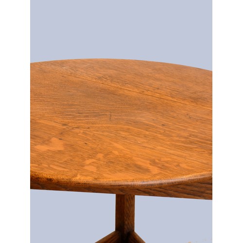 305 - An early 20th Century oak cricket table, the circular top above three outswept legs united by an und... 