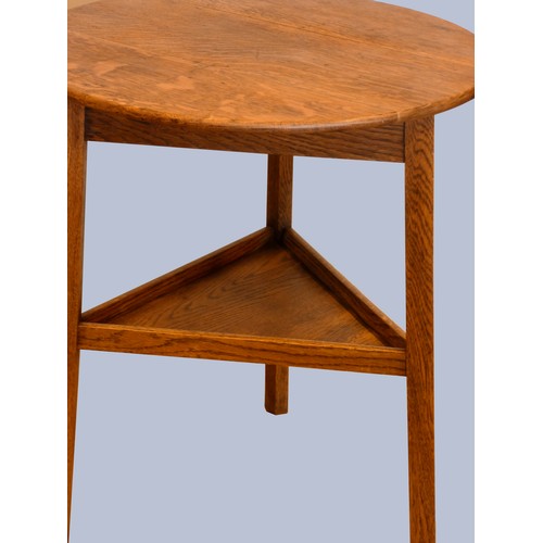 305 - An early 20th Century oak cricket table, the circular top above three outswept legs united by an und... 