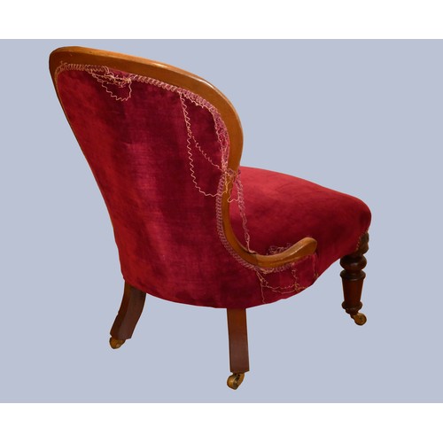 307 - A Victorian mahogany framed nursing chair, having spoon button back, upholstered in a burgundy drylo... 