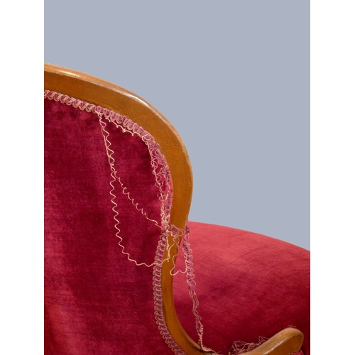 307 - A Victorian mahogany framed nursing chair, having spoon button back, upholstered in a burgundy drylo... 