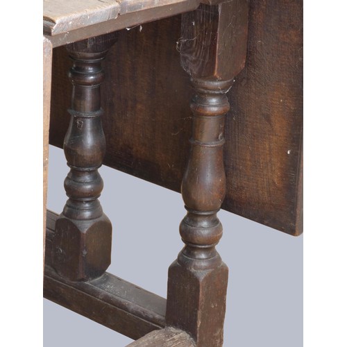 313 - A late 17th century oak gate leg table, with associated rectangular plank top, raised on baluster le... 