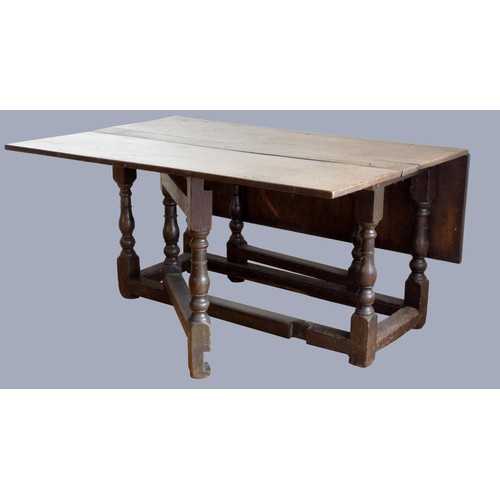 313 - A late 17th century oak gate leg table, with associated rectangular plank top, raised on baluster le... 