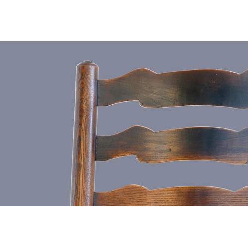 315 - An 18th century oak ladder back rocking chair, with rush seat