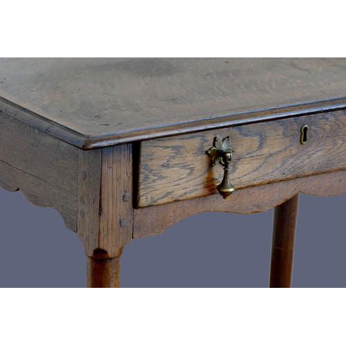 316 - An 18th century oak lowboy, with single frieze drawer, over tapering legs with pad feet.