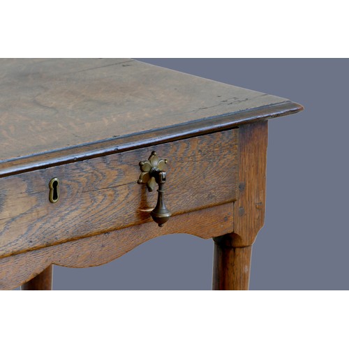 316 - An 18th century oak lowboy, with single frieze drawer, over tapering legs with pad feet.