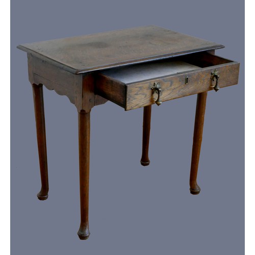 316 - An 18th century oak lowboy, with single frieze drawer, over tapering legs with pad feet.