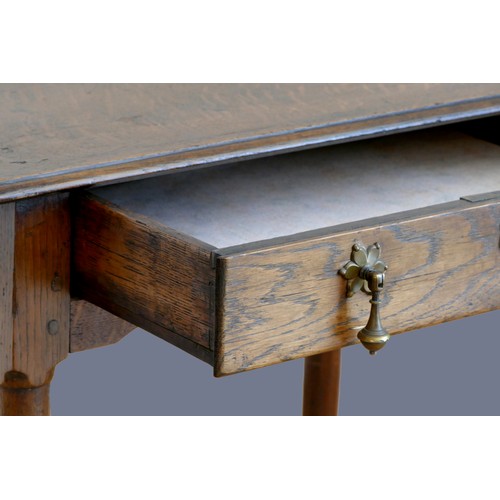 316 - An 18th century oak lowboy, with single frieze drawer, over tapering legs with pad feet.