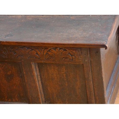 318 - A late 17th century and later oak coffer, with two plank lid over a carved frieze and three panels, ... 