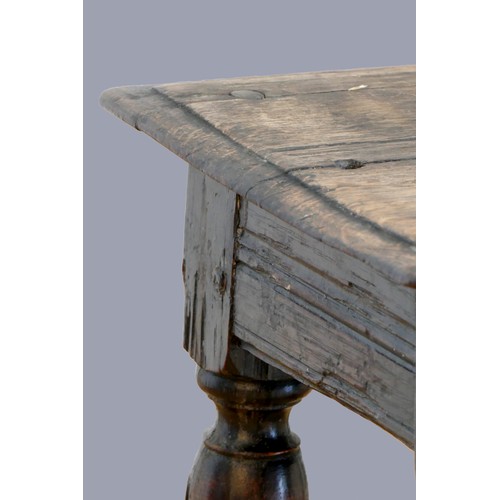 321 - A 17th century oak joint stool, with plank top and thumb nail edge, line incised frieze, on turned b... 