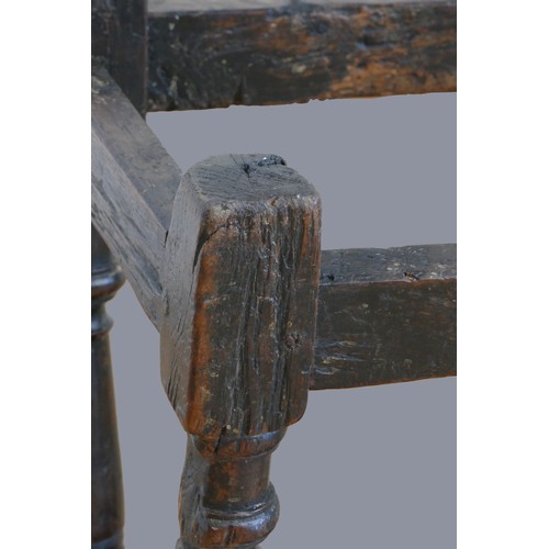 321 - A 17th century oak joint stool, with plank top and thumb nail edge, line incised frieze, on turned b... 