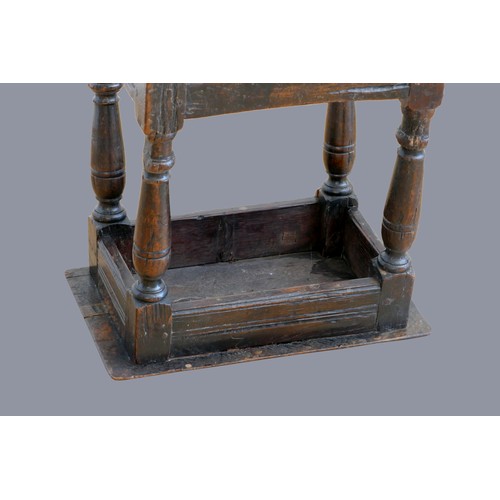 321 - A 17th century oak joint stool, with plank top and thumb nail edge, line incised frieze, on turned b... 