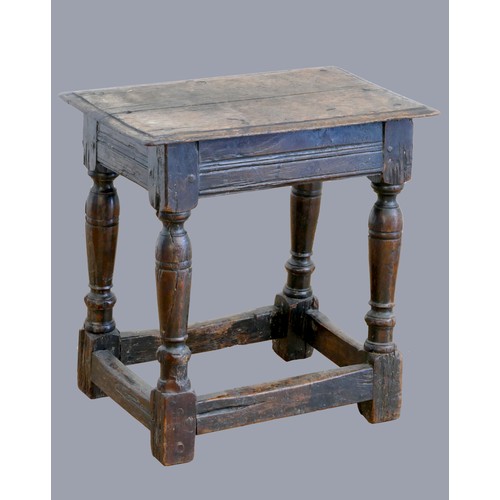 321 - A 17th century oak joint stool, with plank top and thumb nail edge, line incised frieze, on turned b... 